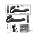 Strap-on-me Remote Vibrating Bendable Strap-on Black Medium with remote and accessories displayed.