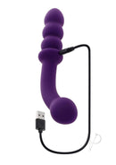 Playboy The Seeker Silicone Dual Vibrator Purple charging with USB cable, showcasing its curved and bulbous design.