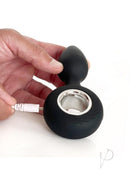 Vers Plug Vibrating Rechargeable Silicone Anal Plug Black being charged with a USB cable and held in a hand.