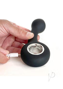 Vers G-Spot Rechargeable Silicone Vibrator Black being recharged with a hand, showcasing its sleek design.