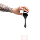 Hand pouring Clone-a-willy Silicone Refill Jet Black into a container, showcasing the glossy black silicone.