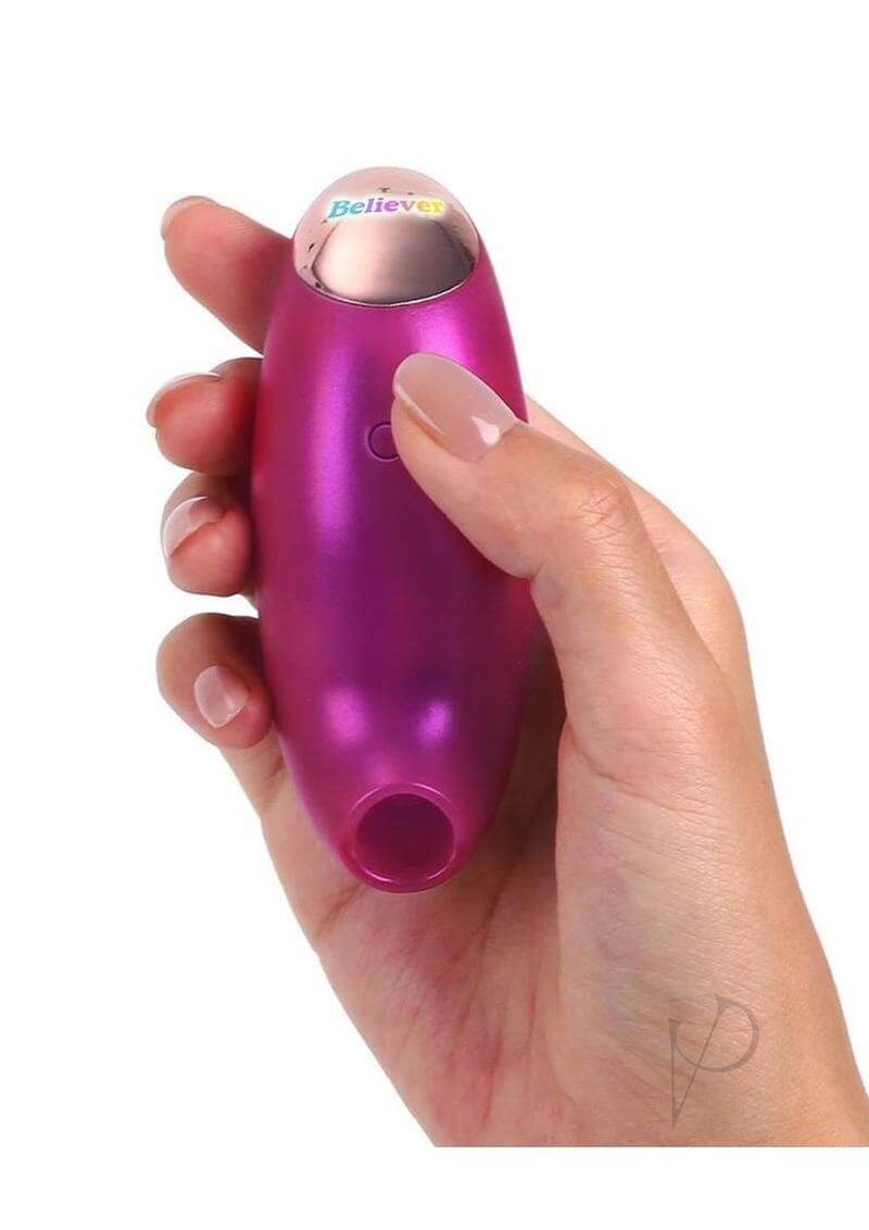 Love to Love Believer Clitoral Stimulator Pink held in a hand, showcasing its sleek design and vibrant color.