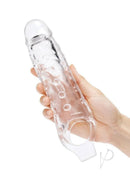 Size Up 1 Inch Studded Clear Penis Extender with Ball Loop held in a hand, showcasing its transparent design and textured surface.