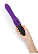 WhipSmart Thrusting Silicone Sex Machine Purple Black held in hand with controls visible.