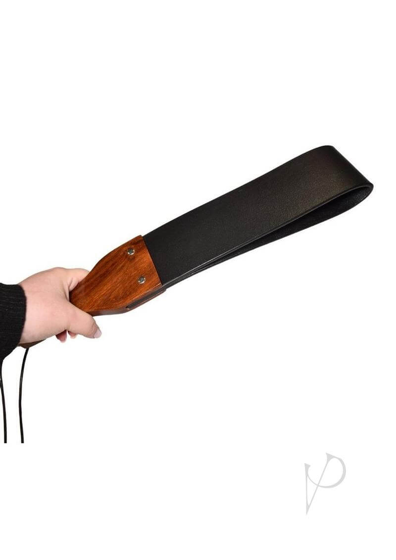 Prowler RED Leather and Wood Flapper Paddle held in hand, showcasing its elegant design and impact play features.