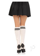Leg Avenue Ribbed Stirrup Leg Warmers OS White worn with a black skirt and high heels, showcasing a trendy look.