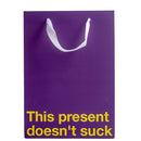This Present Doesn't Suck Color Gift Bag Purple with a cheeky message for humorous gifting.