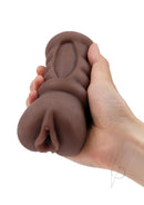 Zolo Stroke Off Diva Pussy Stroker Chocolate held in hand, featuring realistic texture and chocolate hue for enhanced pleasure.