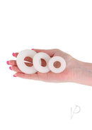 Firefly Bubble Ring Glow in the Dark Cock Ring Set White displayed in a hand, featuring three assorted sizes.