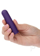 Person holding Turbo Buzz Rechargeable Rounded Bullet Purple stimulator in hand for discreet pleasure.