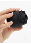 Hand holding Fifty Shades of Grey Rose Clitoral Suction Stimulator in black with delicate petals.