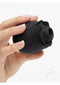 Hand holding Fifty Shades of Grey Rose Clitoral Suction Stimulator in black with delicate petals.