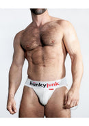 Hunker Comfy Pouch Slider-Strap Jock White Snow XXLarge modeled by a muscular man, showcasing comfort and support.