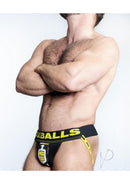 Oxballs PissPig 3D Rubber Urinal Jock Black Yellow Large model showcasing front pouch design and bold graphics.