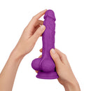 FemmeFunn Vortex Turbo Baller 8.25 inch Rotating Dildo Purple held in hands showing premium silicone design.