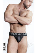 Model wearing Oxballs Airmesh Swagger Jock Strap Tar Black XXLarge, showcasing breathable fabric and supportive design.