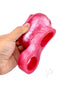 Monstar Beast Silicone Penis Sleeve Pink held in hand showcasing its vibrant design and unique features.