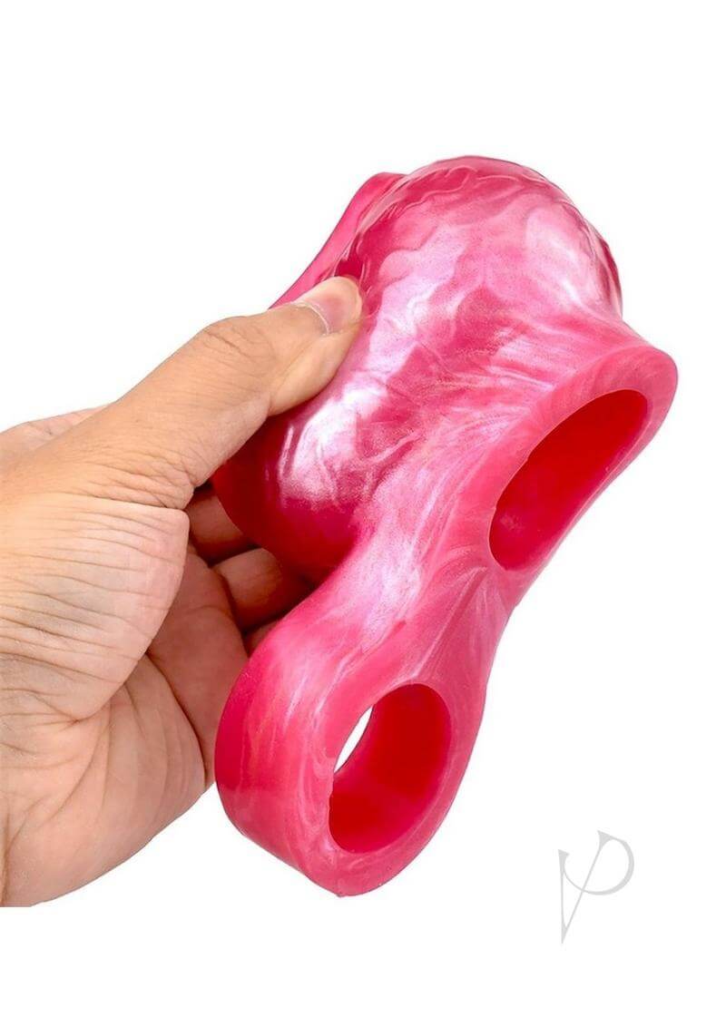 Monstar Beast Silicone Penis Sleeve Pink held in hand showcasing its vibrant design and unique features.
