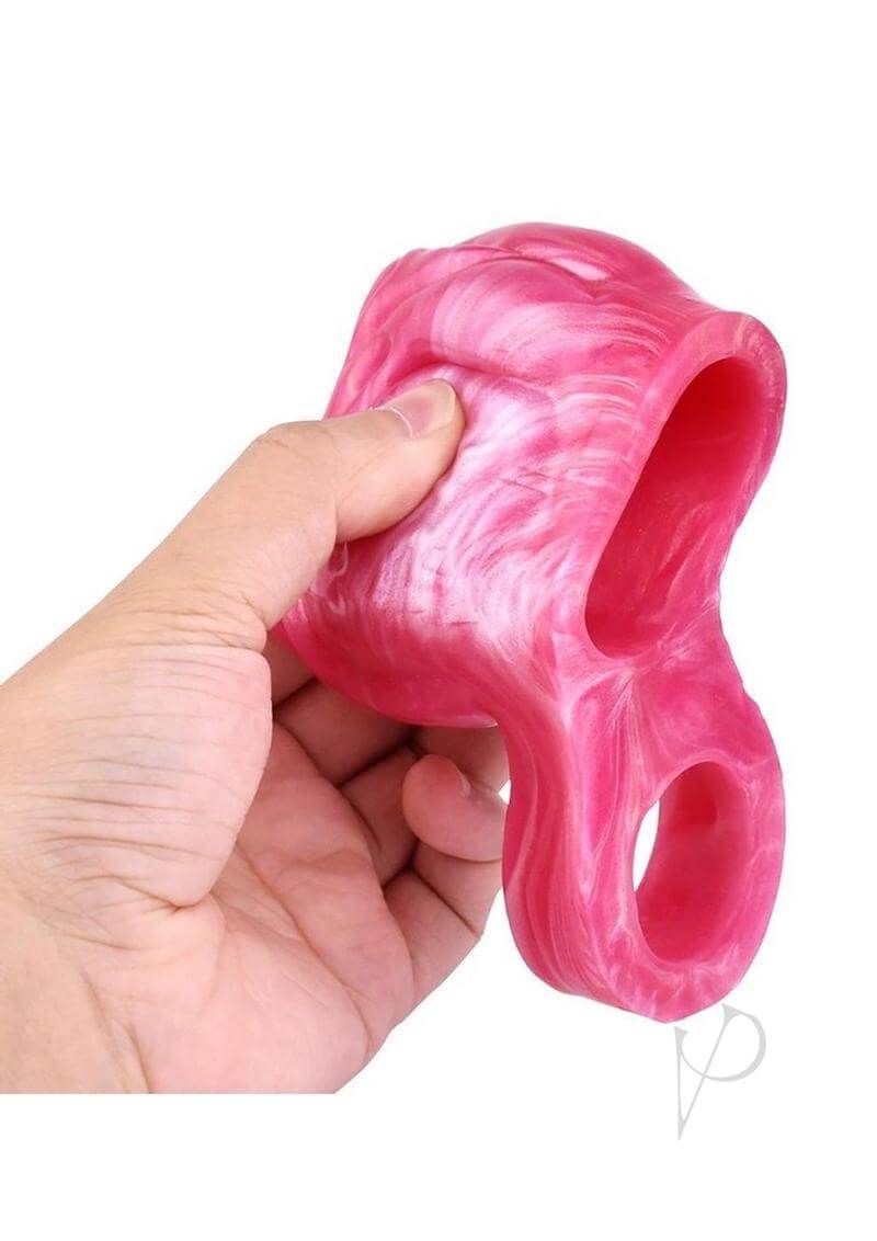 Monstar Beast Silicone Penis Sleeve 13 Pink White held in hand, showcasing its flexible design and premium silicone material.