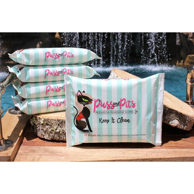 Puss and Pits Wipes 15 Pack, premium feminine wipes for freshening up, displayed beside a water feature.