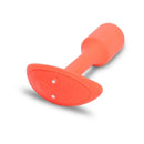b-Vibe Vibrating Snug Plug 1 Weighted Silicone Anal Plug Orange laying on a surface