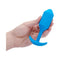b Vibe Vibrating Snug Plug 3 Weighted Silicone Anal Plug Blue held in a hand, showcasing its ergonomic design and vibrant color.