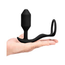 b-Vibe Vibrating Snug & Tug Weighted Anal Plug with Cockring Medium held in a hand, showcasing its compact design.