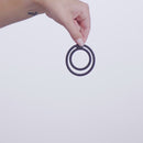Nexus Double Enduro Silicone Cock and Ball Ring Black held by a hand against a light background.