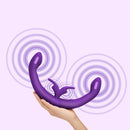 Together Couples Toy Remote Controlled Dual Ended Vibrator Purple in a person's hand with wave patterns.