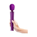 Le Wand Petite Rechargeable Massager Dark Cherry held in hand, designed for powerful performance and versatile settings.