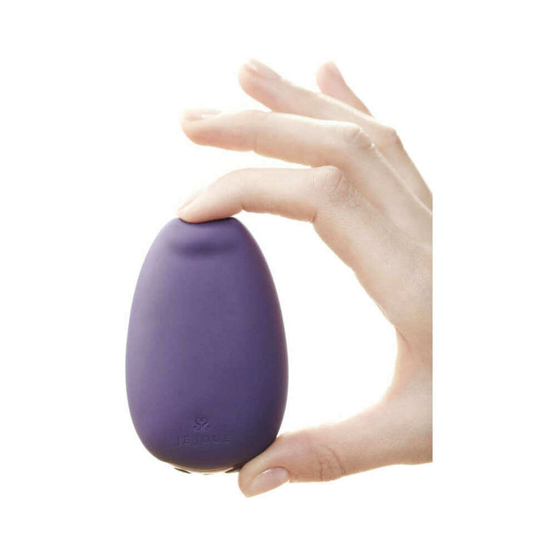 Je Joue Mimi Soft Silicone Clitoral Vibrator Purple held in hand, showcasing its sleek design and soft silicone material.