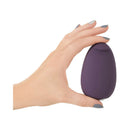 Je Joue Mimi Soft Silicone Clitoral Vibrator Purple held in hand showcasing its sleek design.
