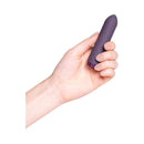 Je Joue Classic Bullet Vibrator Purple held in a hand showcasing its compact design and functionality.
