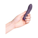 Hand holding the Je Joue G-Spot Bullet Vibrator Rechargeable Silicone Purple for targeted stimulation.