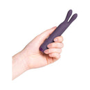 Je Joue Rabbit Bullet Vibrator Purple held in a hand, showcasing its playful design and compact size.