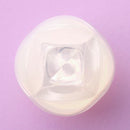 Iroha Petit Lily Disposable Clitoral Massager Clear viewed from above on a purple background.