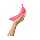 Love To Love Oh Oui Silicone Banana Vibrator Pink held in hand, featuring a playful design and smooth texture.