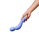 Dame Com Rechargeable Silicone Wand Vibrator Periwinkle in a hand, showcasing its ergonomic design and soft silicone material.