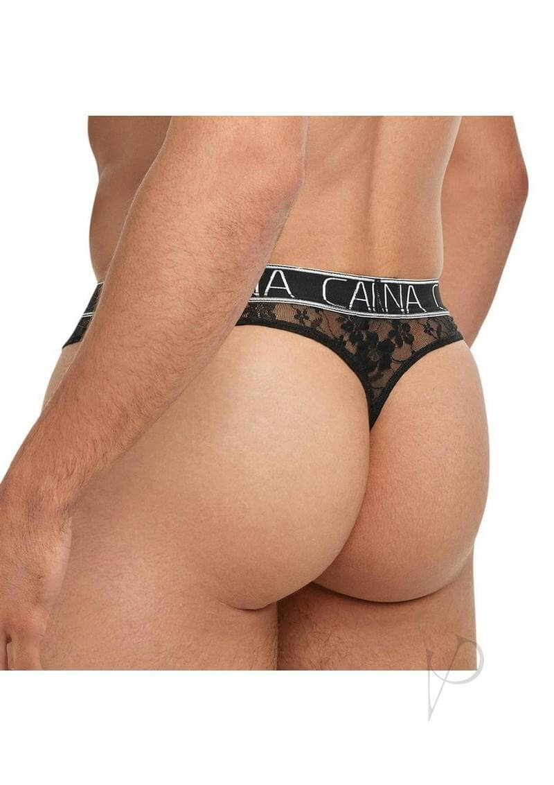 Male model wearing Banana Cabana Lace Nights Thong Small Medium Black showcasing sheer lace design.
