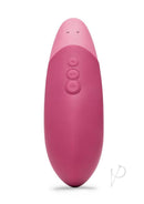 Dusky pink Womanizer Vibe clitoral vibrator with UltraWave Vibration technology and ergonomic design for enhanced pleasure.