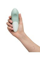 Hand holding Womanizer Vibe Sage clitoral vibrator with ergonomic design and UltraWave Vibration technology.