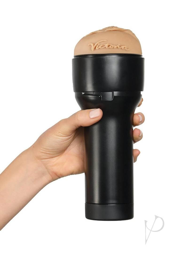 Hand holding Kiiroo Feel Victoria June Stroker with realistic design and Victoria's signature on top.