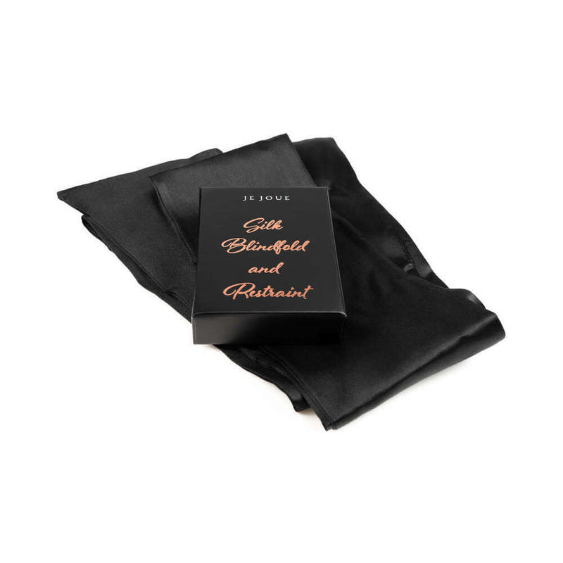 Je Joue The Naughty Collection 4 Piece Gift Set featuring silk blindfold and restraint packaging on a smooth surface.