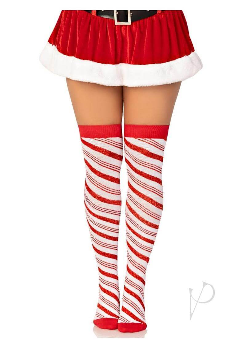 Peppermint striped over-the-knee socks in red and white worn with a festive Santa skirt, perfect for holiday parties.