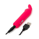 Happy Rabbit Silicone Bullet Vibrator With Ears Pink next to USB charging cable.