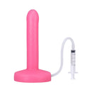Tantus Pop Slim Squirting Dildo Watermelon in pink with syringe attachment for fluid release.