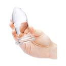 b-Vibe 4 Piece Anal Dilators Glass Plug Set held in hand, showcasing its sleek design and smooth texture.