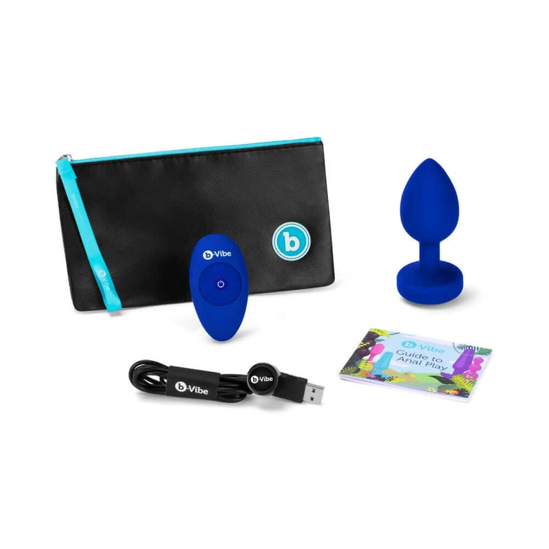 b-Vibe Vibrating Jewel Remote Controlled Anal Plug L XL with remote, charging cable, storage pouch, and guide.