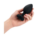 b-Vibe Remote-Controlled Anal Plug XX-Large held in a hand, showcasing its elegant design and smooth texture.