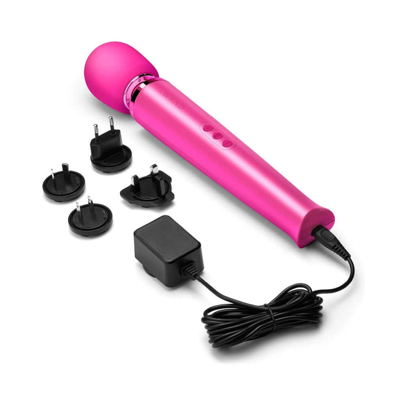 Le Wand Rechargeable Vibrating Massager Magenta with power adapters and charging cord.